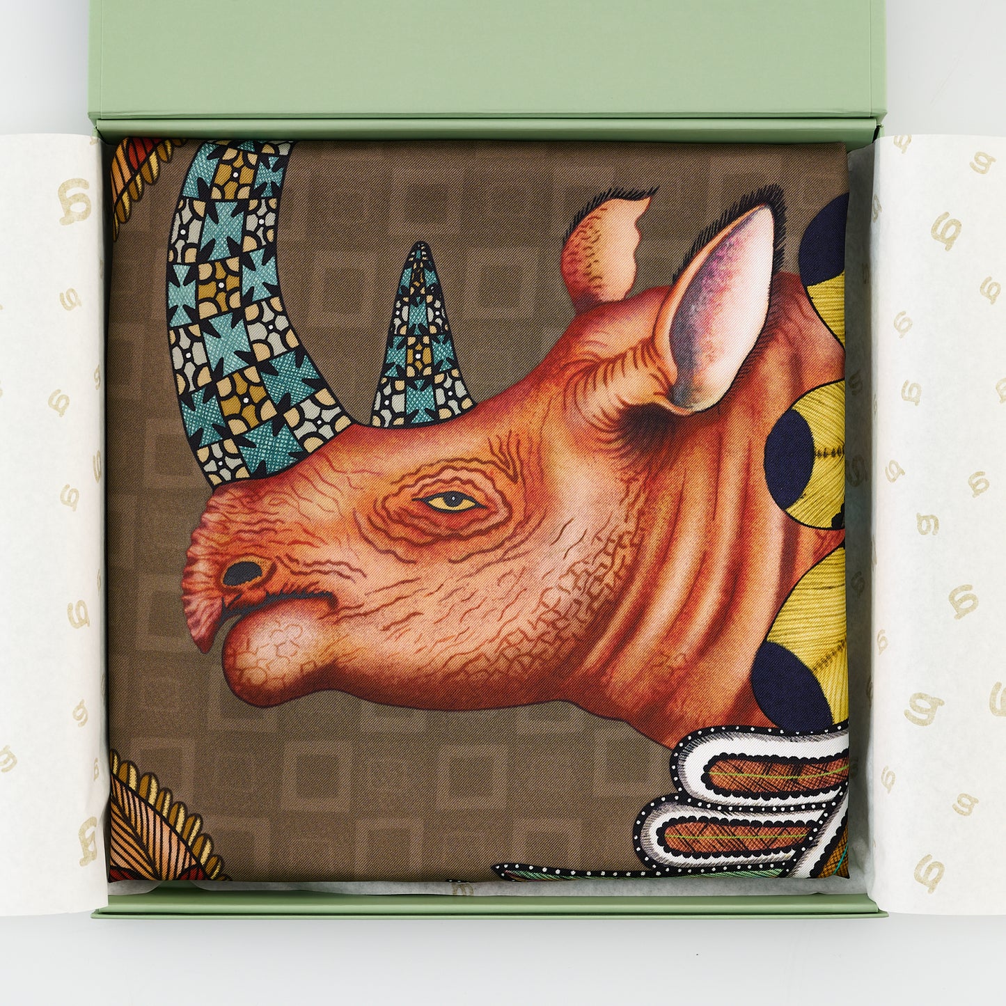 A section showing a stylised rhino with traditional African motifs, blending earthy tones with intricate Zulu beadwork-inspired design.