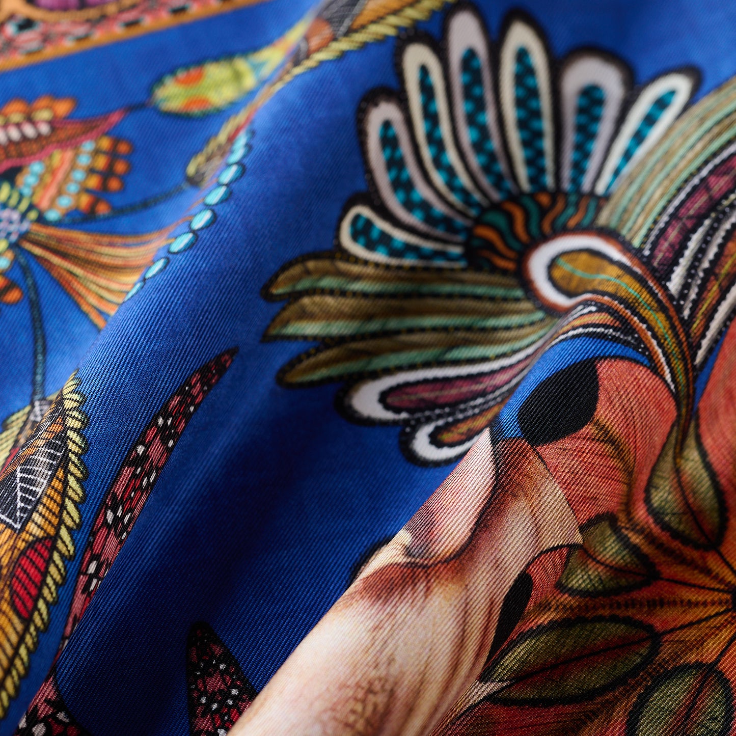 A zoomed-in view highlighting the vibrant hues, intricate detailing, and sheen of the luxurious silk material.