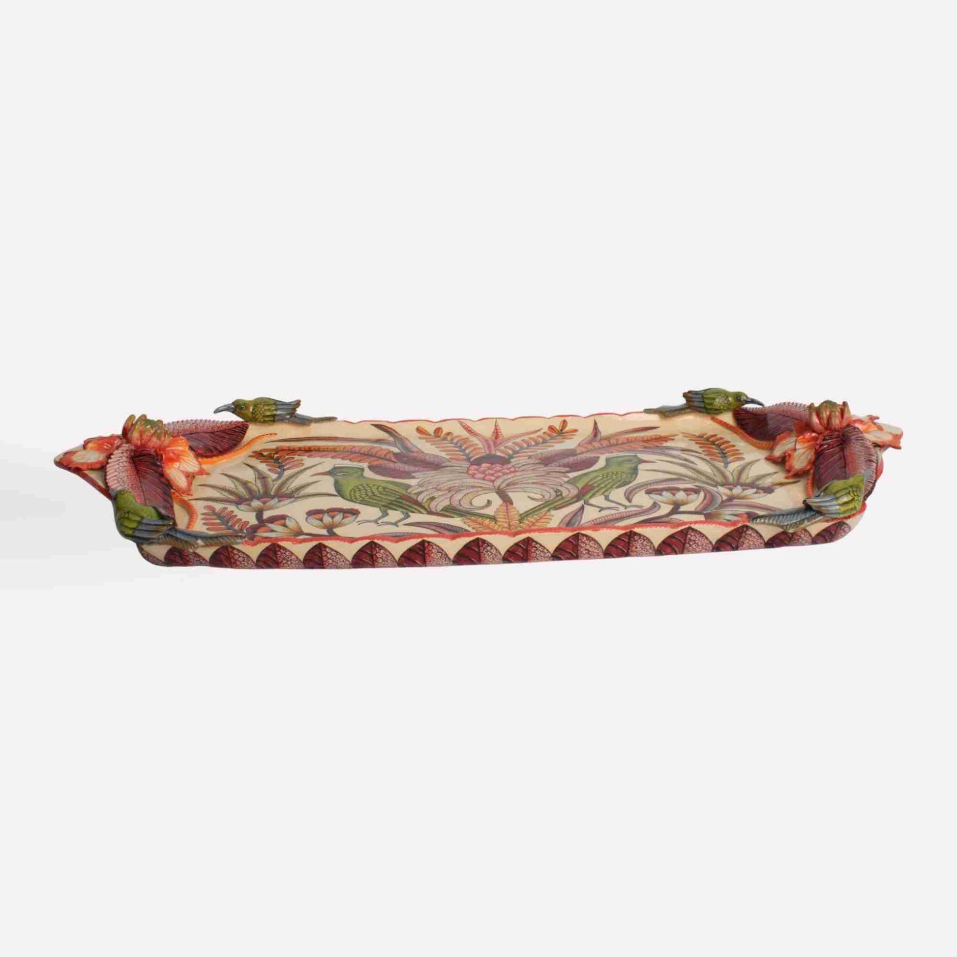  A side perspective that reveals the full length of the platter, showcasing its sculptural details and hand-painted embellishments.