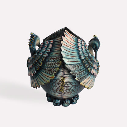 A side-angle view showcasing the heron’s expansive, textured wings and elegant body structure. The reflective glaze enhances the depth of the craftsmanship.