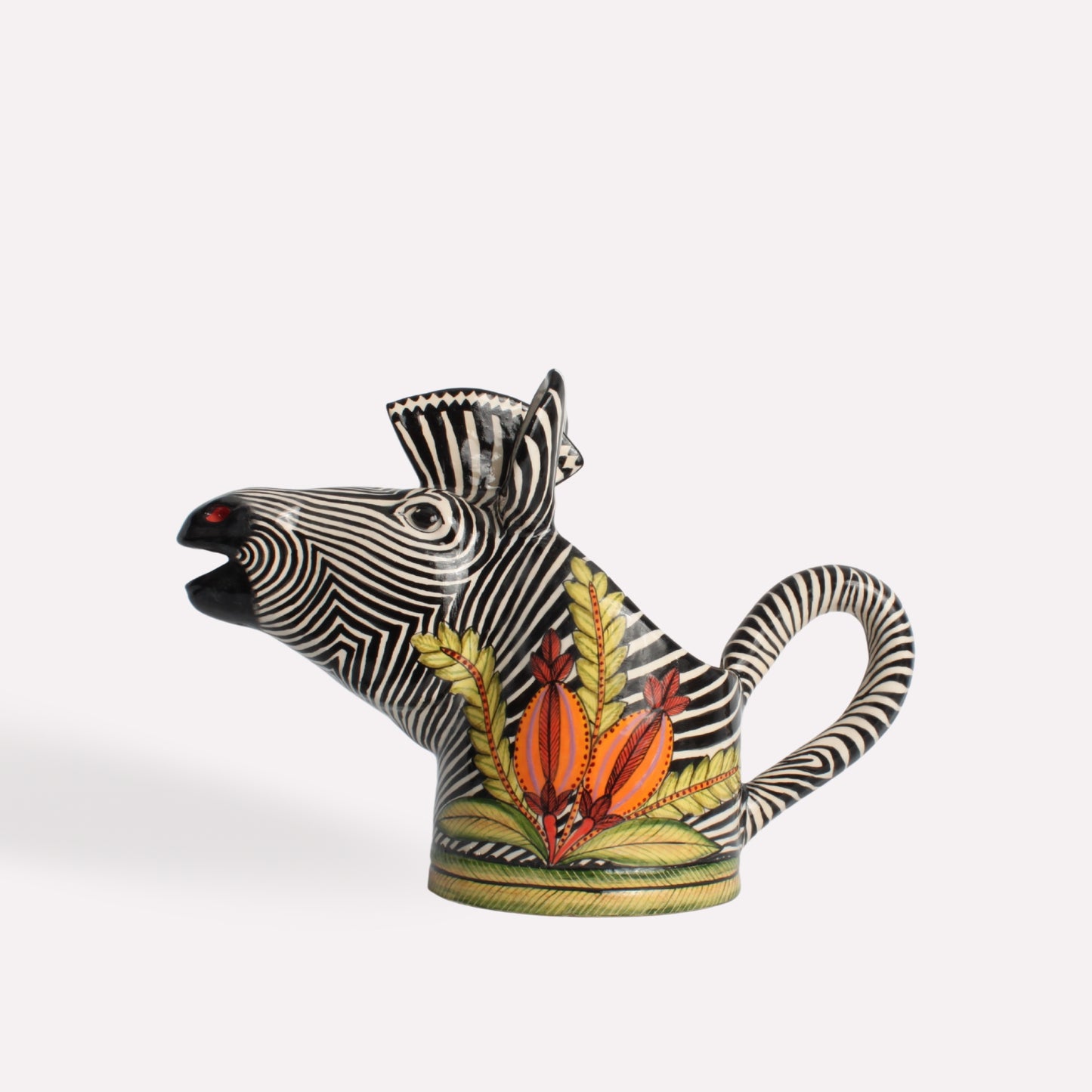 A side-angle perspective of the zebra head jug, showcasing its distinctive handle, elongated snout, and striking contrast of natural zebra patterns with colourful design elements.