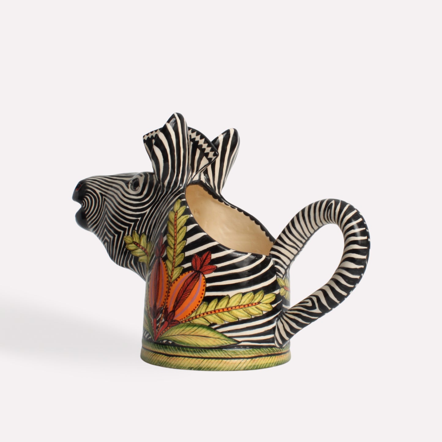 A three-quarter view of the jug, capturing its sculptural form, unique craftsmanship, and the fusion of functional art with African wildlife-inspired motifs.