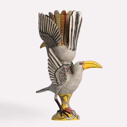 A side-angle perspective showcasing the vase’s sculptural elements, with the hornbill’s wings raised high and fanned out, adding depth and texture to the design.