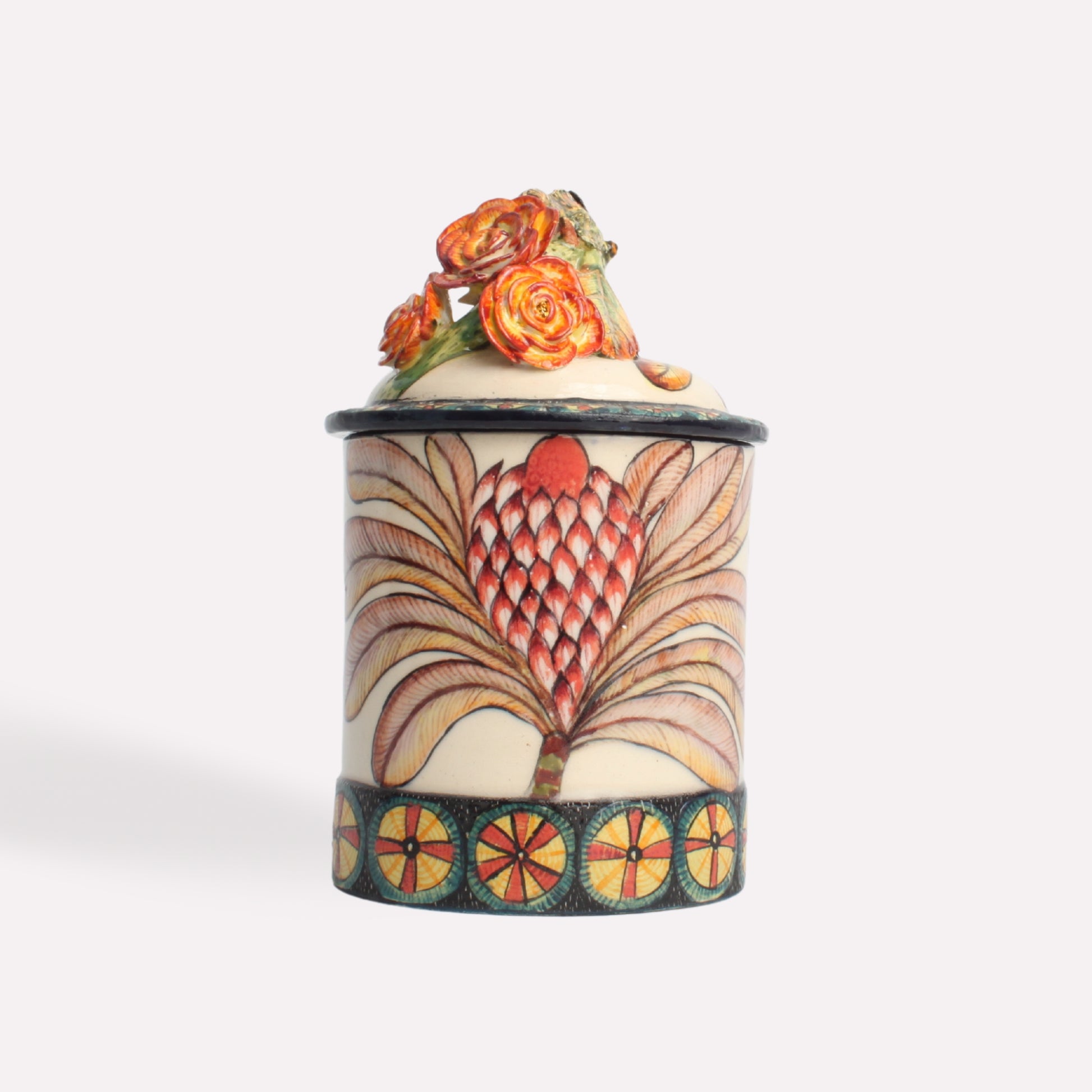 A side-angle image of the candle jar, showcasing the vibrant chameleon design and the intricate hand-painted artwork on the container.