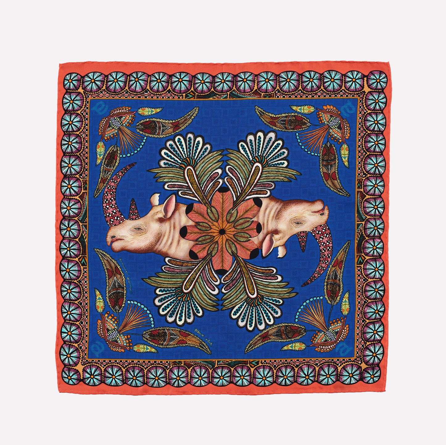 A rich blue silk pocket square featuring two mirrored rhinos with ornately patterned horns, framed by a border of floral and circular motifs inspired by traditional Zulu beadwork.