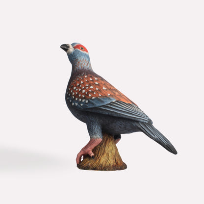 A side view of the Speckled Pigeon sculpture, displaying its intricate wing patterns, soft grey and red tones, and subtle speckling on the feathers.