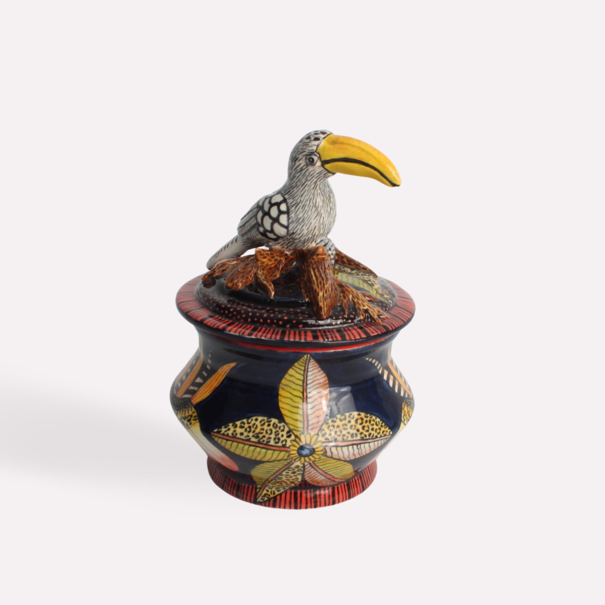 A slightly angled perspective showcasing the detailed artwork, the hornbill lid, and the vibrant African-inspired motifs encircling the box.