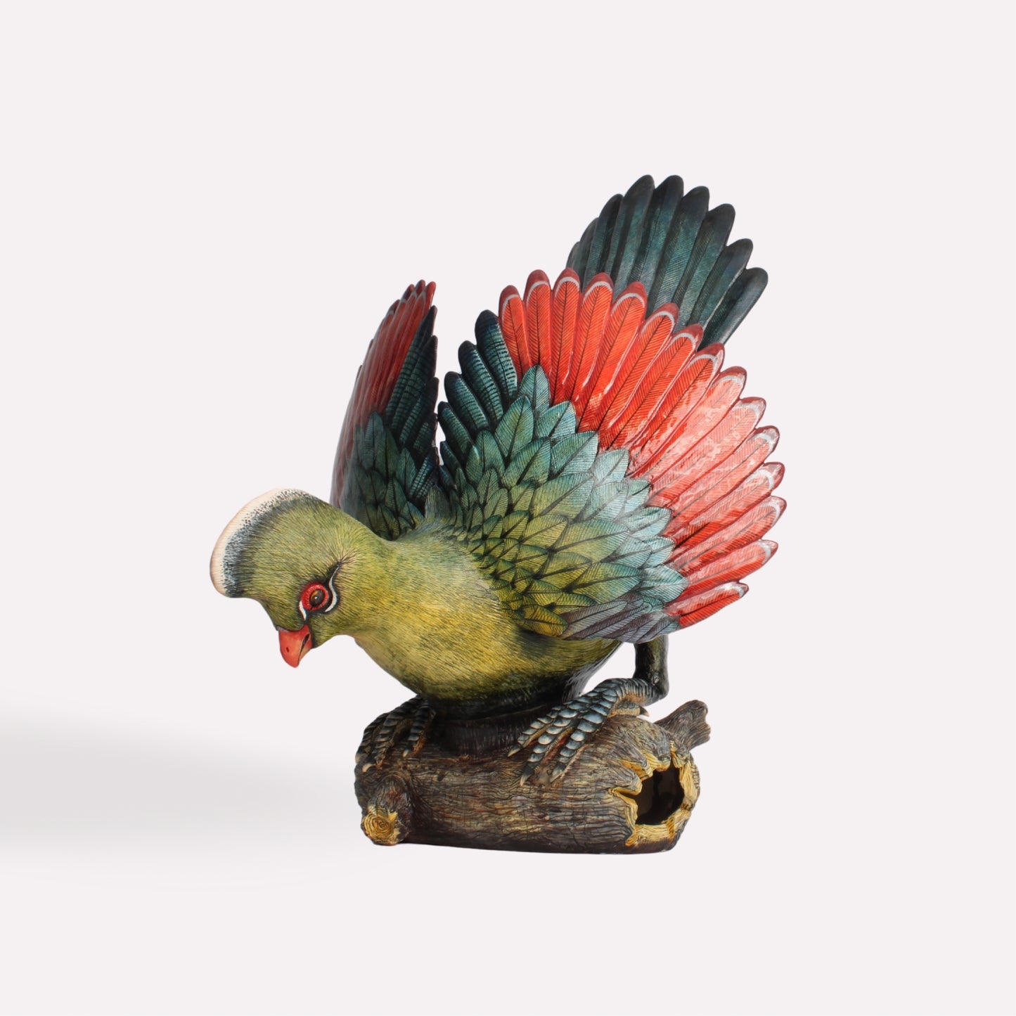 A side-angle view of the Turaco sculpture, showcasing the intricate hand-painted detailing, layered feathers, and expressive pose.