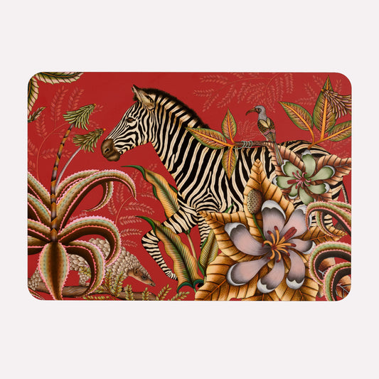 A hardboard placemat featuring an elegant zebra surrounded by exotic flora, magnolias, and flowering aloes on a deep red background.