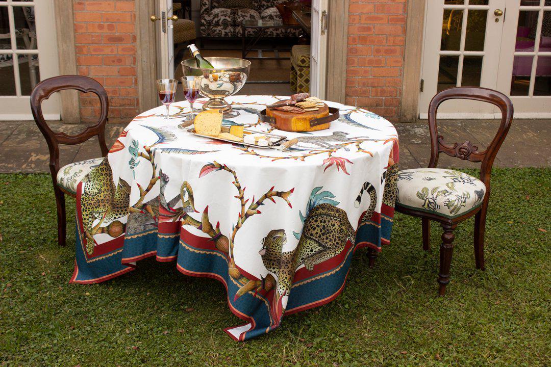 A beautifully set outdoor dining area featuring the Monkey Paradise Square Tablecloth, styled with elegant tableware and surrounded by lush greenery.