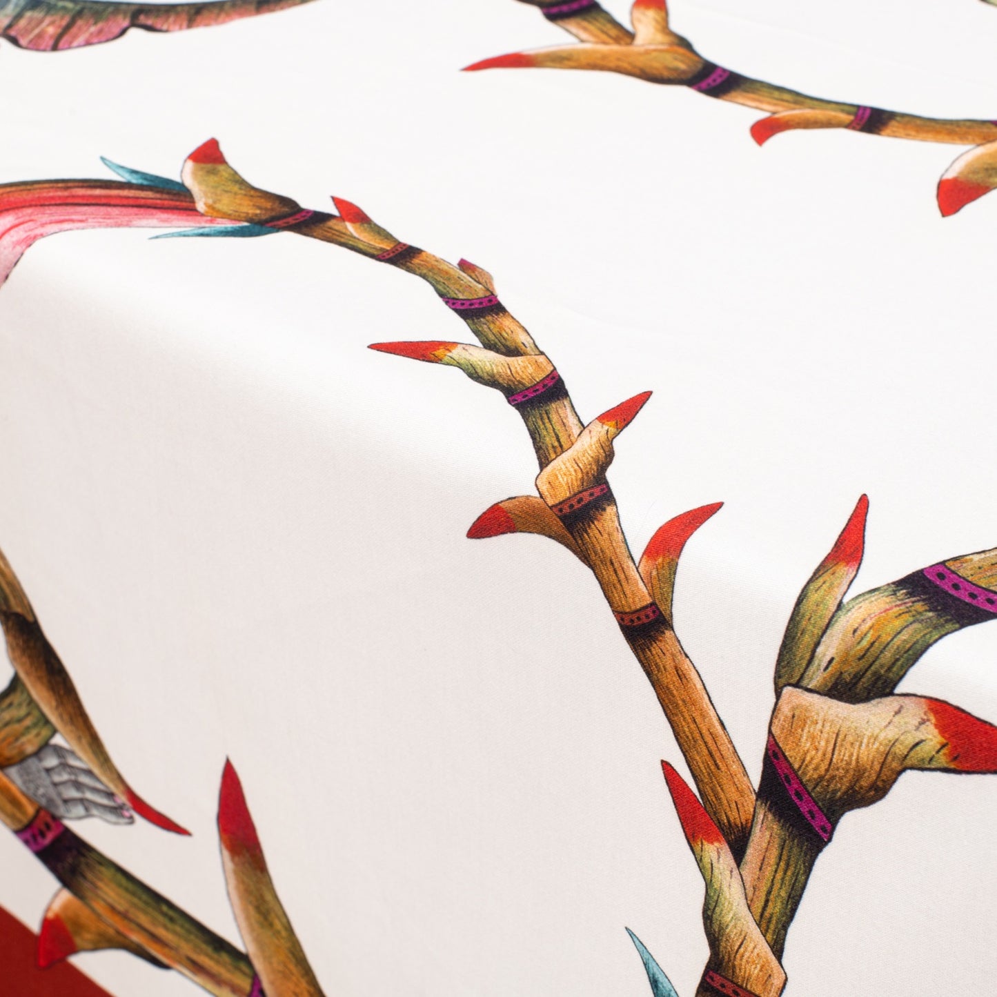 A detailed close-up of a bird of paradise among floral elements and branches.